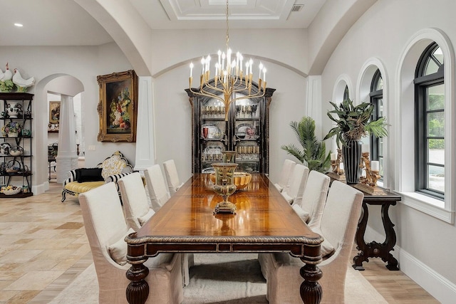 dining room featuring visible vents, baseboards, a chandelier, and stone finish flooring