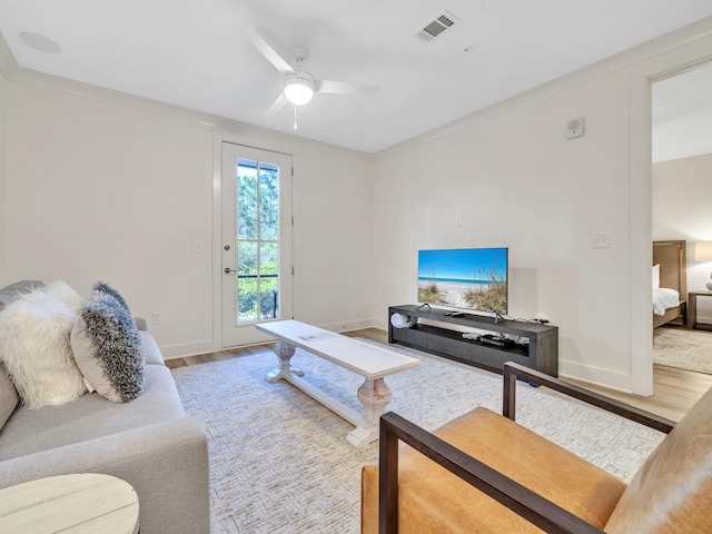 living room with hardwood / wood-style floors and ceiling fan