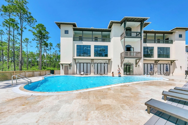 view of pool with pool water feature and a patio