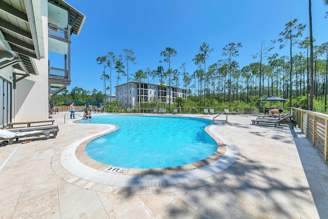 view of swimming pool with a patio area and pool water feature