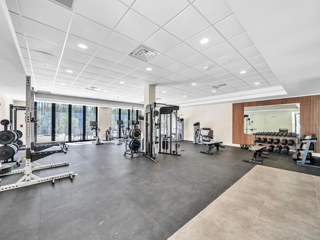 gym with a paneled ceiling