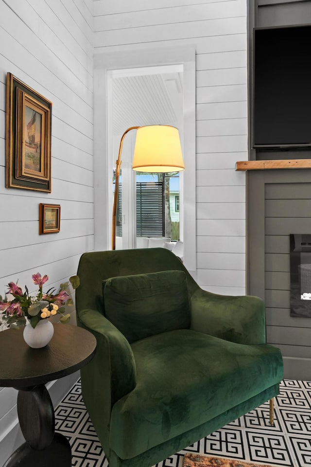 living area featuring wood walls