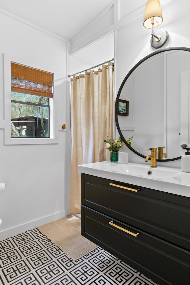 bathroom with tile patterned floors, a shower with curtain, vanity, and ornamental molding