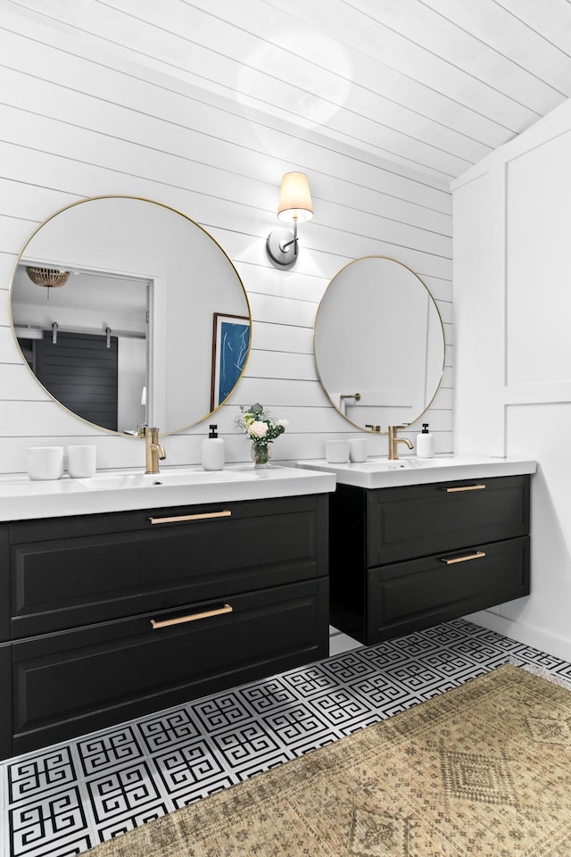 bathroom with vanity and wooden walls