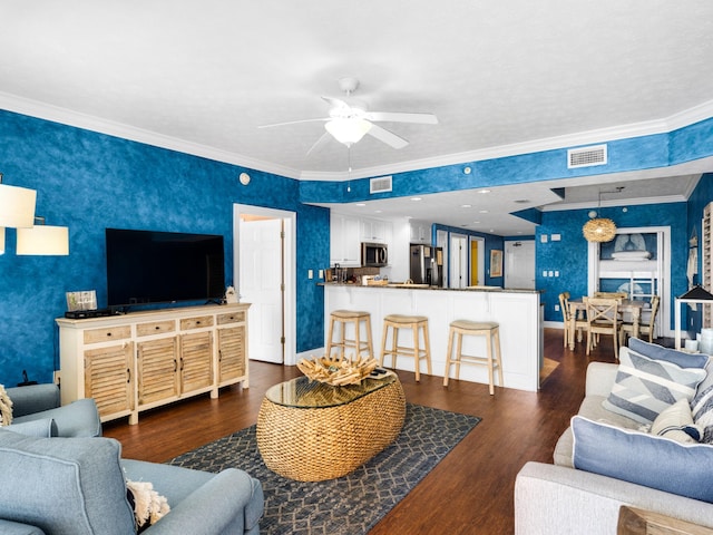 living room featuring dark hardwood / wood-style floors, ceiling fan, and ornamental molding