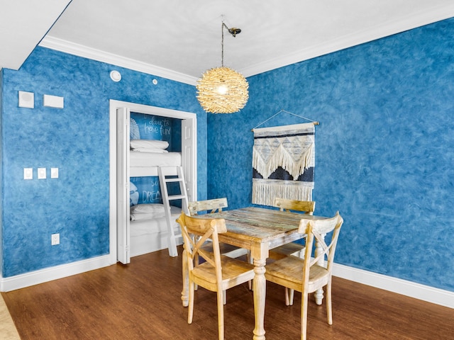 dining space with dark hardwood / wood-style flooring and ornamental molding