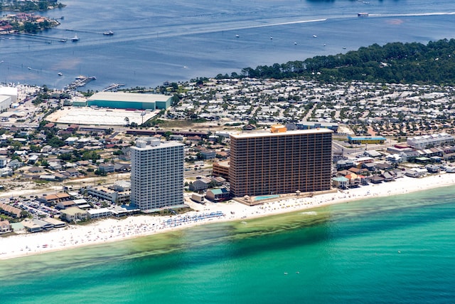 birds eye view of property featuring a beach view and a water view