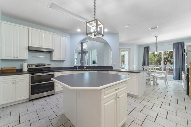 kitchen featuring stainless steel electric stove, decorative light fixtures, a kitchen island, and light tile floors