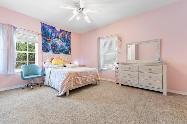 bedroom featuring carpet, multiple windows, and ceiling fan