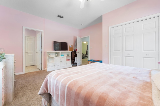 bedroom with light carpet, a closet, and ceiling fan