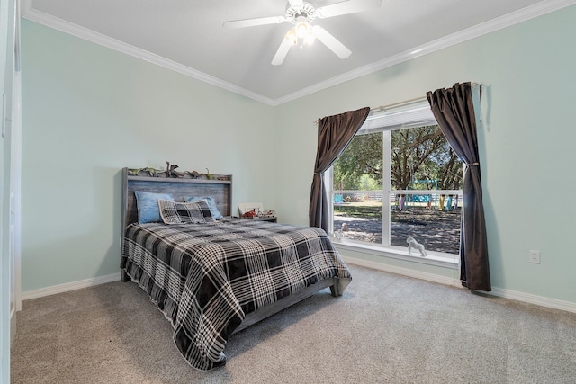 carpeted bedroom featuring ceiling fan and crown molding