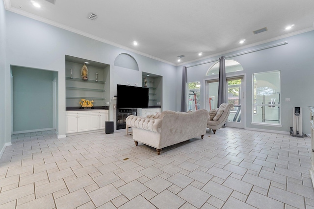 living room with ornamental molding, built in shelves, and light tile flooring