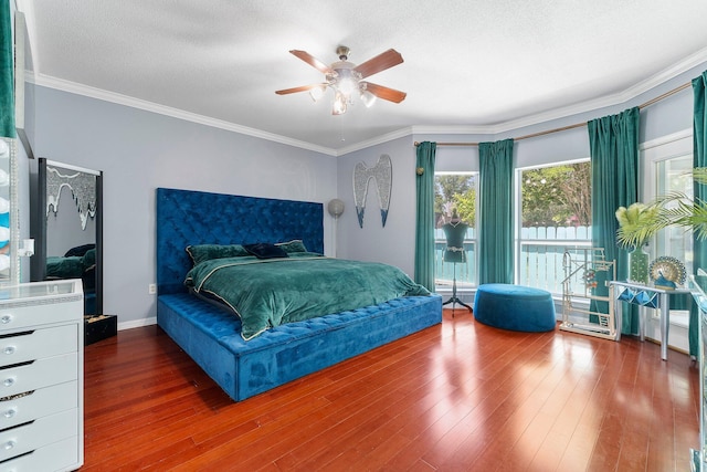 bedroom with ceiling fan, a textured ceiling, hardwood / wood-style flooring, and ornamental molding