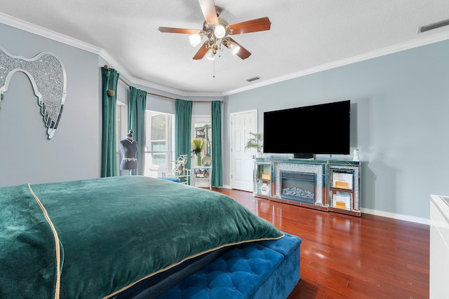 bedroom featuring ceiling fan, crown molding, and hardwood / wood-style flooring