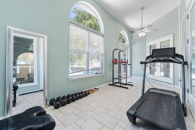 exercise room with a wealth of natural light, high vaulted ceiling, ceiling fan, and light tile floors