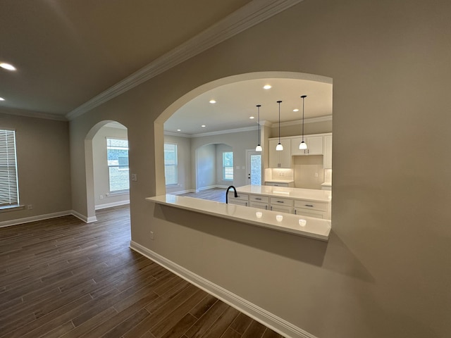 kitchen with white cabinets, plenty of natural light, dark wood-type flooring, and hanging light fixtures