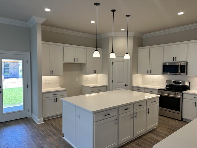 kitchen featuring white cabinets, pendant lighting, and stainless steel appliances