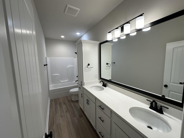 full bathroom with vanity, toilet, wood-type flooring, and bathtub / shower combination