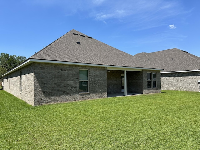 rear view of house with a patio area and a yard