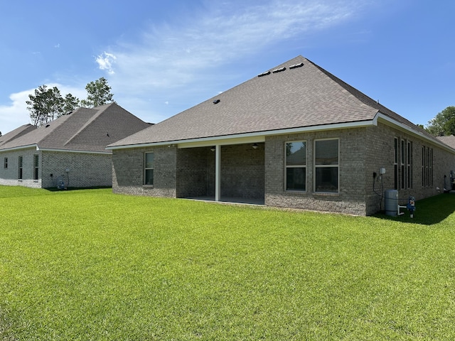 rear view of property with a lawn