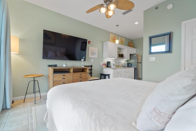 bedroom with stainless steel refrigerator, ceiling fan, and light tile floors