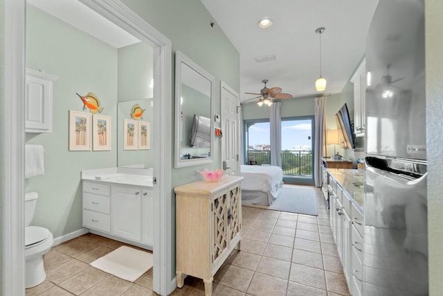 bathroom with vanity, tile flooring, ceiling fan, and toilet