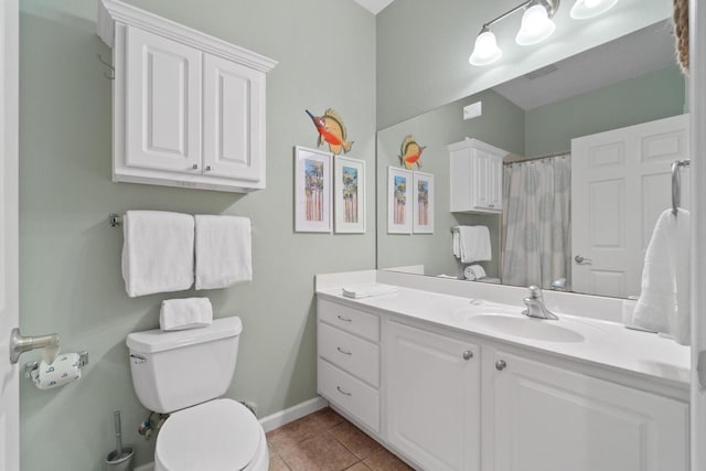 bathroom with tile flooring, large vanity, and toilet