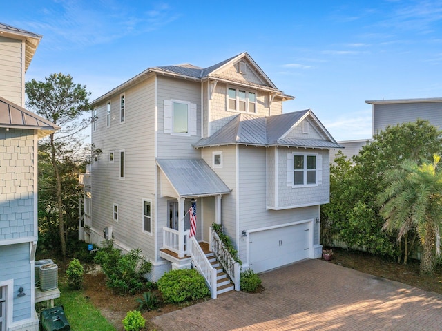 view of front of home with a garage and cooling unit