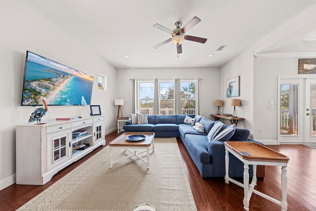 living room featuring dark hardwood / wood-style flooring and ceiling fan