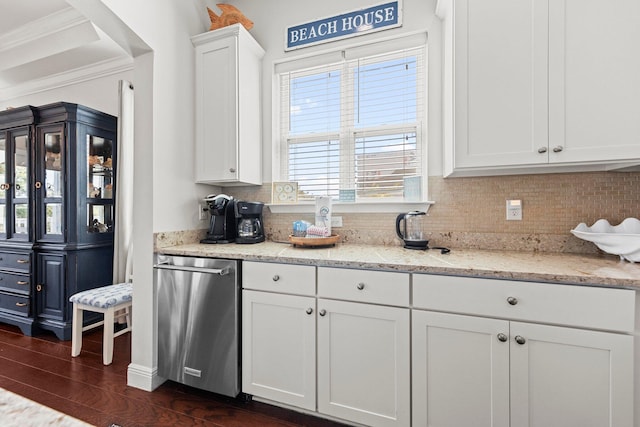 kitchen featuring decorative backsplash, white cabinetry, stainless steel dishwasher, and light stone countertops