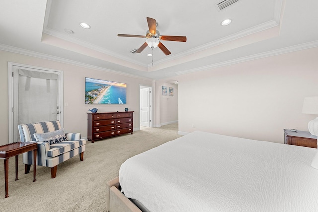 bedroom featuring ceiling fan, light colored carpet, and a tray ceiling