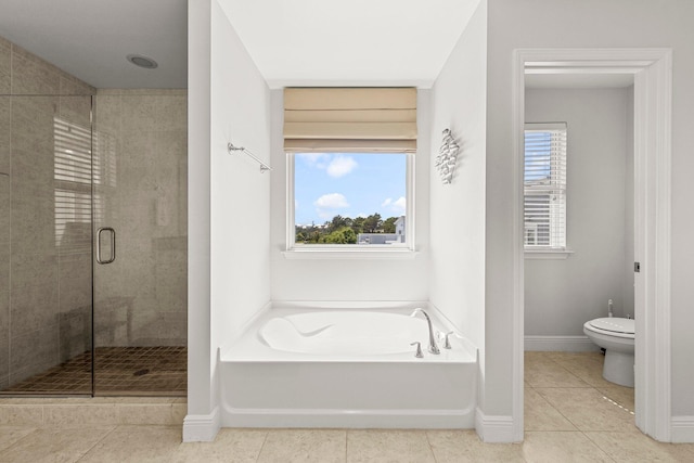 bathroom with tile patterned floors, separate shower and tub, and toilet