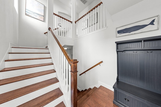 stairs featuring wood-type flooring