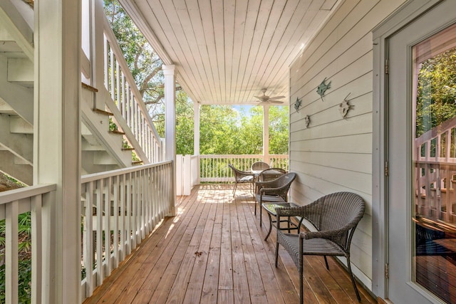 deck with ceiling fan and covered porch