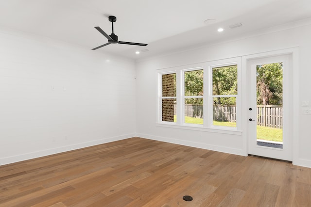 spare room featuring ceiling fan, light hardwood / wood-style flooring, and crown molding