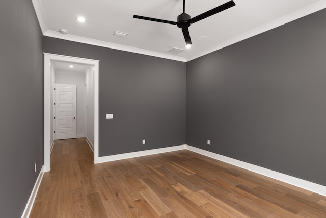 spare room with hardwood / wood-style flooring, ceiling fan, and ornamental molding