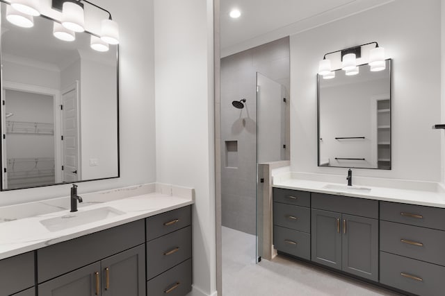 bathroom featuring vanity, ornamental molding, and walk in shower