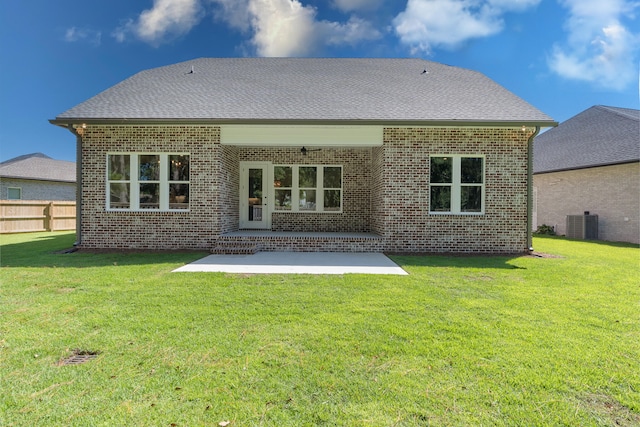 back of property featuring a lawn and a patio