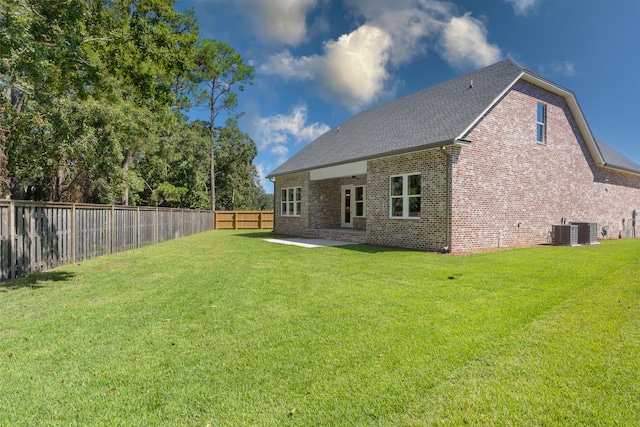 back of property featuring cooling unit, a patio area, and a lawn