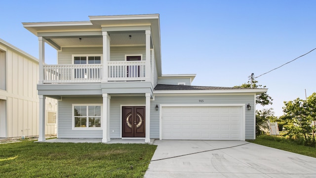 view of front facade featuring a garage, a balcony, and a front lawn