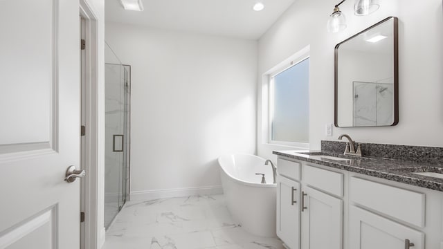 bathroom with vanity and shower with separate bathtub