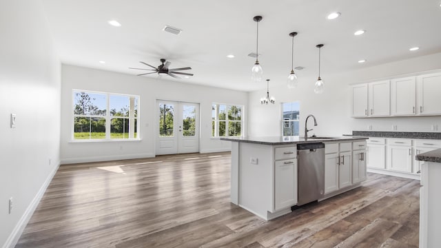 kitchen with dishwasher, white cabinetry, hanging light fixtures, and an island with sink