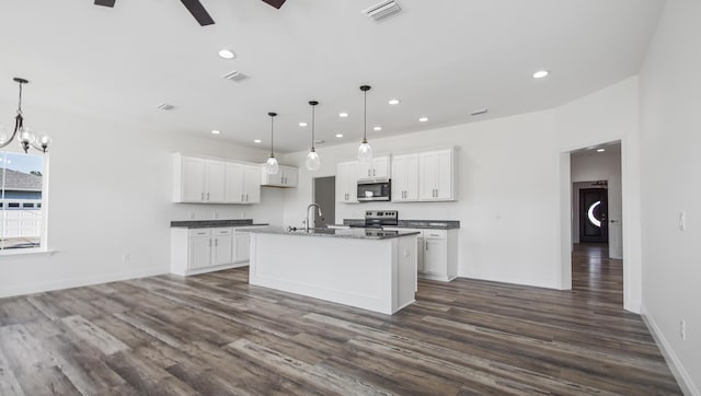 kitchen featuring white cabinetry, a center island with sink, stainless steel appliances, and decorative light fixtures