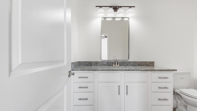 bathroom with vanity and toilet