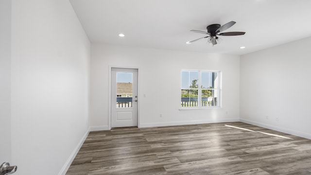 spare room with ceiling fan and dark hardwood / wood-style floors