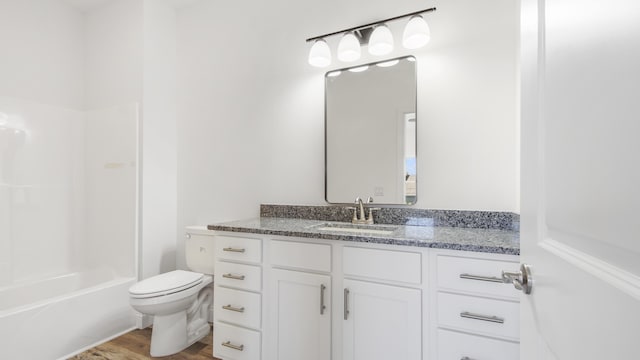 full bathroom with vanity, hardwood / wood-style flooring, toilet, and tub / shower combination