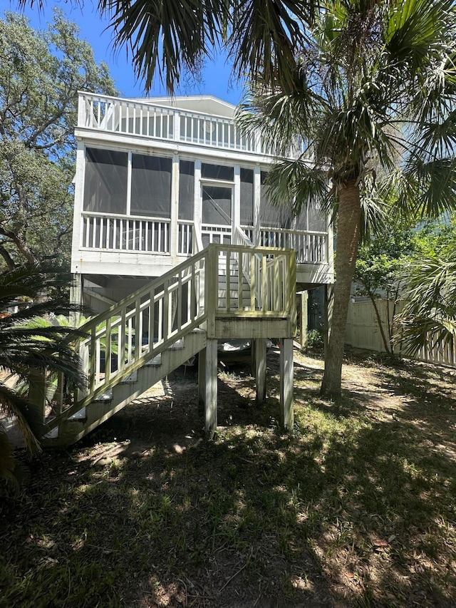 back of property with a sunroom