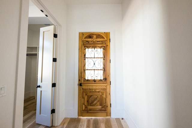 hallway with wood-type flooring