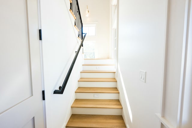 stairs with hardwood / wood-style floors