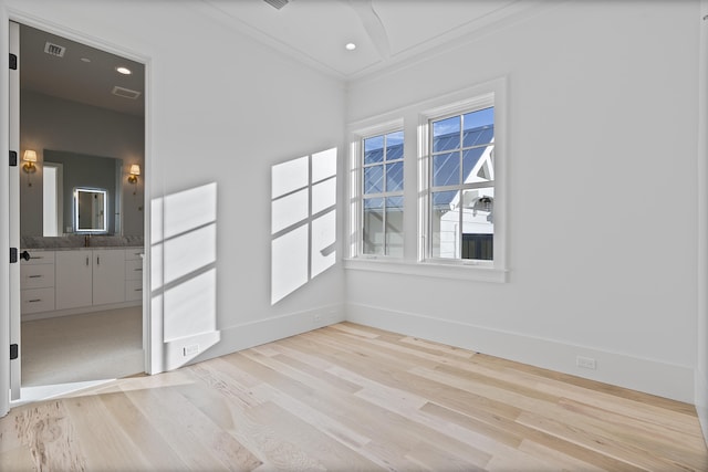 unfurnished room with crown molding and light wood-type flooring